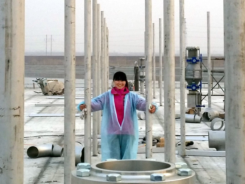 woman posing near equipment at construction site
