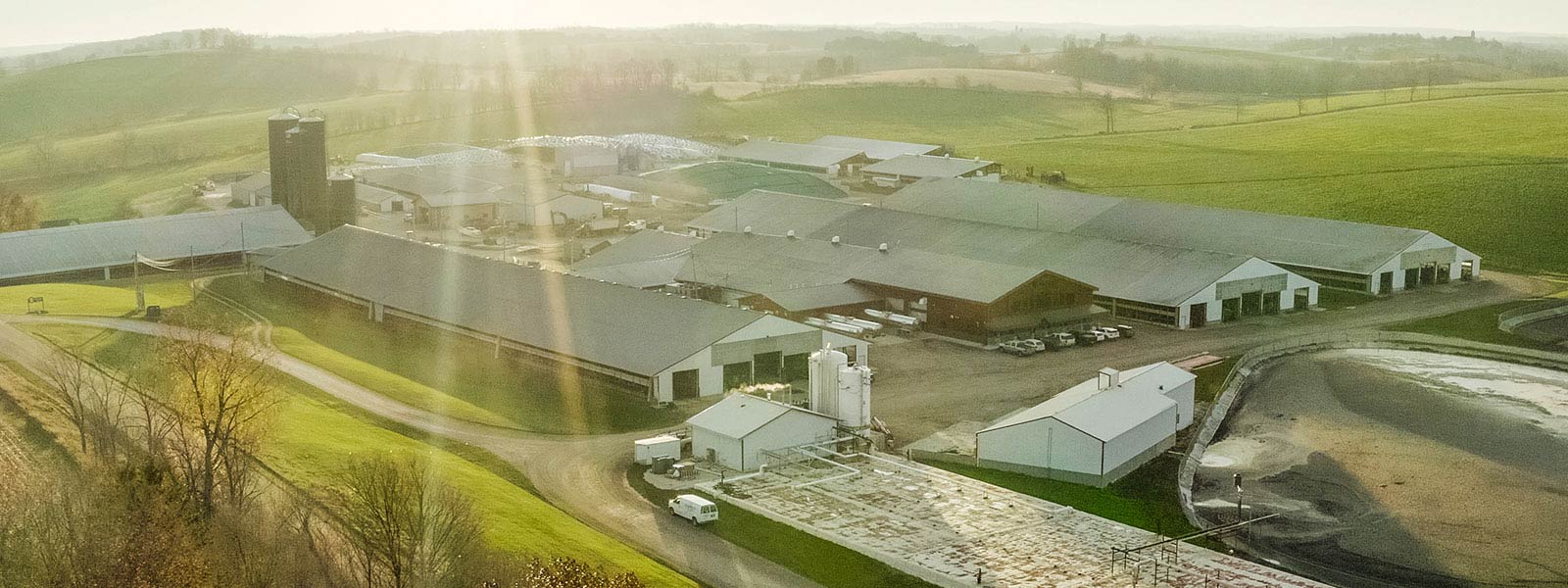 aerial photo of a dairy farm with a two-stage linear vortex anaerobic digester in the foreground