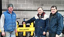 three men smiling at the camera