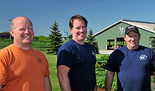 three men smiling at the camera